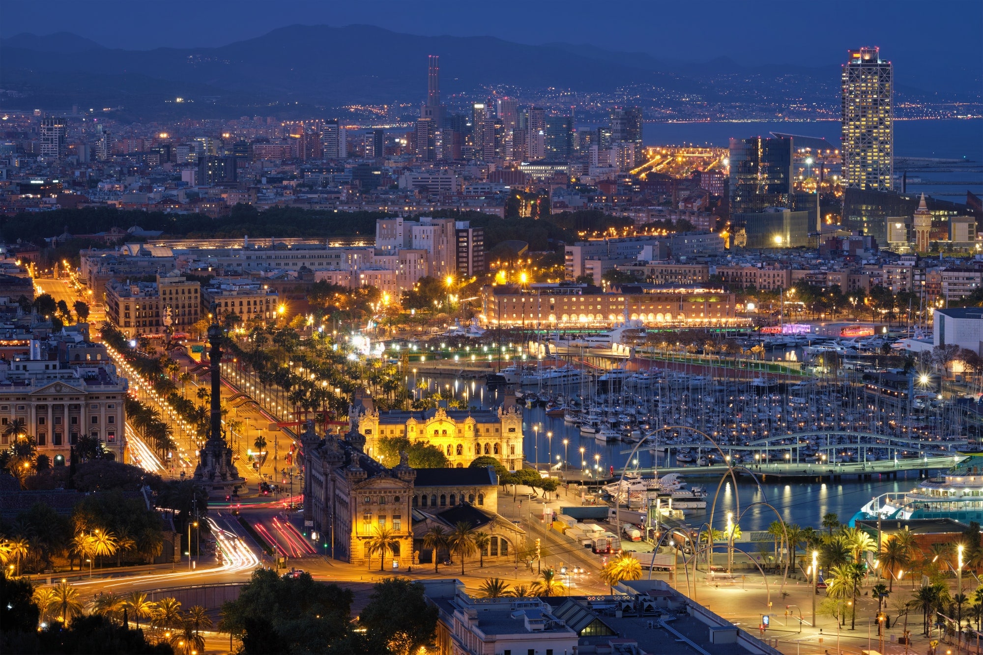 Aerial view of Barcelona city and port with yachts