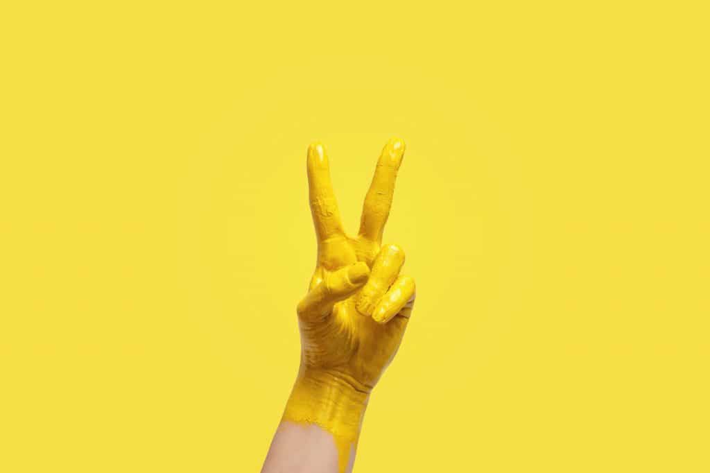 Victory or peace hand gesture, color of te 2021 year