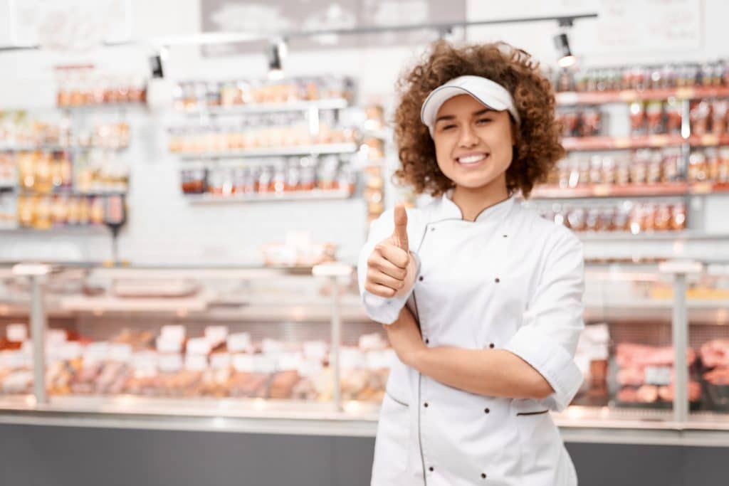 Shop worker showing thumb