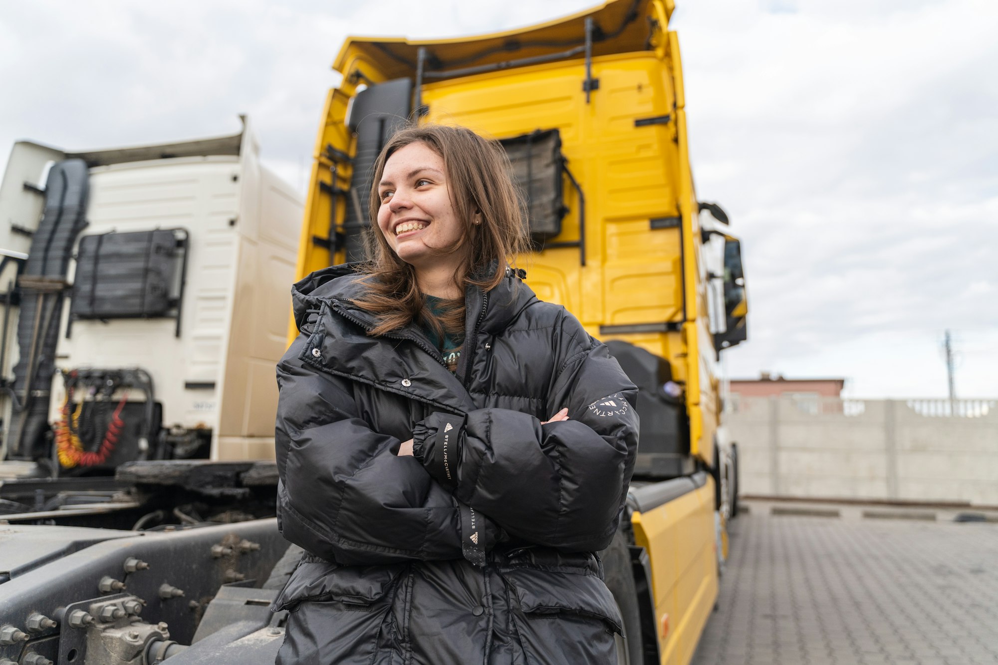 Caucasian young woman driving truck. trucker female worker, transport industry occupation